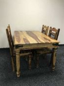 A rectangular pine kitchen table together with four chairs