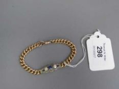 A two stone diamond and sapphire bracelet on gold bracelet, 26.9g.
