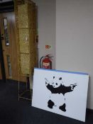 A 6' wicker floor lamp and two Banksy canvas pictures