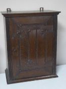 An oak arts and crafts wall cabinet
