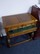 An early 20th century oak cutlery table fitted three drawers containing a part set of EPNS cutlery
