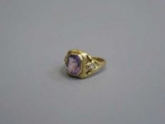 A Georgian gold ring set with an amethyst and old cut diamond shoulders, 5.4g, ring size L.