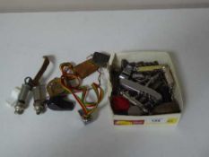 A box containing a large collection of whistles, pen knives,