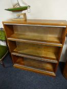 A triple-section stacking bookcase with sliding glass doors