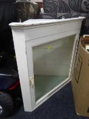 A painted corner cabinet