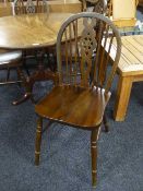 A set of four oak wheel back chairs