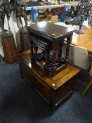 An oak blanket box and a nest of three oak tables