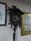 A Black Forest cuckoo clock with pendulum and weights