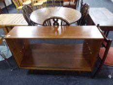A teak sliding door bookcase
