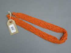 An antique multi-strand coral necklace with yellow metal clasp