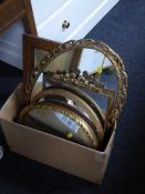 Four gilt framed mirrors and an oak framed mirror