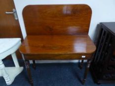 A Victorian mahogany foldover tea table