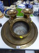 A large circular brass wall plaque,