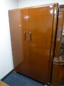 A mid 20th century walnut double door wardrobe