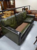 A re-upholstery project - a green leather three seater settee,