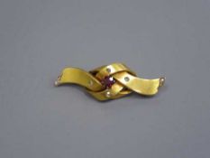 A Victorian gold brooch set with rose-cut diamonds and a ruby, stamped 18, 6.2g.