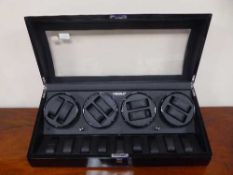 A Modalo black lacquered electronic watch display box with compartments for nine wrist watches,