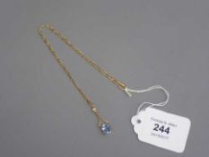 An Edwardian gold necklace set with a small pearl and aquamarine pendant