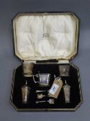 A five piece silver cruet set in case with set of three salt spoons, all parts cased.