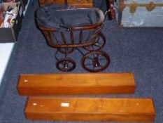 A vintage style doll's pram and two wooden storage cases