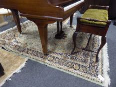 A fringed Keshan Persian carpet 230 cm x 160 cm on green ground