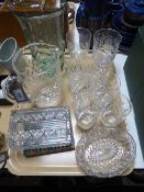 A tray containing commemorative etched glasses, a hand-blown green glass vase,