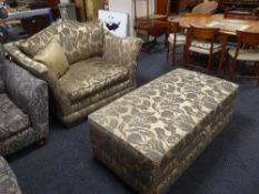 A contemporary floral upholstered armchair and a storage footstool (2)