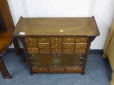 A Chinese multi drawer cabinet with double doors