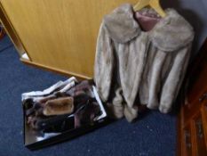 A box containing a quantity of assorted lady's fur stoles, wraps etc,