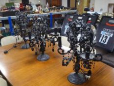 A set of three black ornate table lamps with glass drops