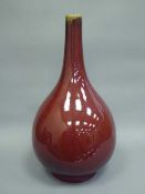 A Chinese Sang de boeuf bottle vase, with blue six character mark to base, height 35 cm.