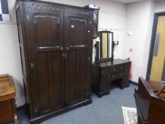 A Stanley Wood of Olney carved oak double door wardrobe and matching dressing table