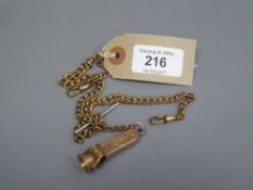 A 9ct gold-faced cheroot cutter suspended upon a gilt metal chain