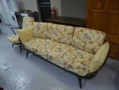 An Ercol panel back settee and an armchair