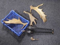 A basket containing three antlers together with a pair of wooden juggling clubs and a wooden pipe