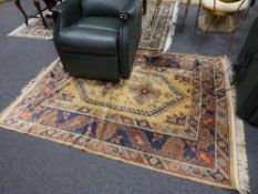 A fringed Persian carpet on golden ground