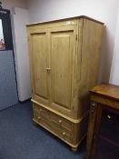 A pine child's wardrobe fitted three drawers