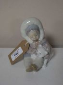 A Lladro figure of an Inuit girl with polar bear
