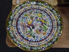 A large Spanish ceramic charger with bird and flower decoration