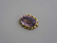 An early twentieth century gold brooch mounted with an amethyst, stamped 14K.