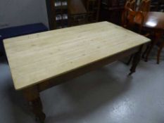 A pine topped farmhouse dining table on antique mahogany base