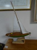 An Ailsa pond yacht on wooden stand