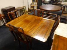 A mahogany extending dining table and four Late Victorian chairs