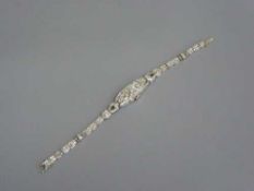 A lady's platinum and diamond set Longines cocktail watch, set with round, tapered,