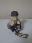 A Royal Copenhagen figure of a Satyrs with snake