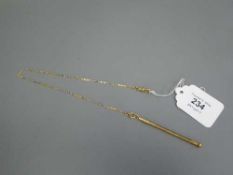 A 9ct gold propelling pencil (5.3g )suspended upon an 18ct gold chain (5.