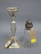 A silver candlestick, together with a silver mounted sifter.