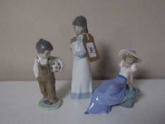 Three Nao figurines, girl with puppy,