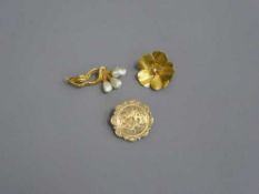 Three yellow metal brooches, two set with pearls.
