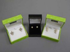 Three pairs of pearl earrings set in gold, one 18ct.